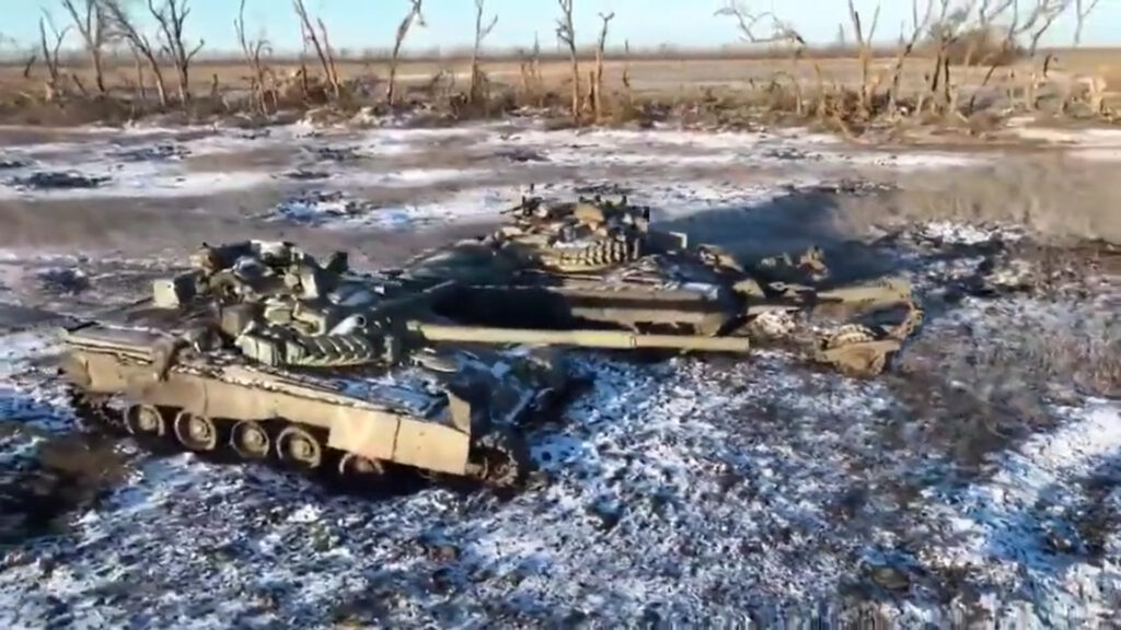 two damaged-abandoned Russian T-80BV tanks one with a KMT-7 mineroller by Ukraine’s 68th Jager Brigade on the Vuhledar front